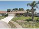 Inviting single Gathering home showing off a well manicured lawn, brick design, and ample parking at 8521 Caitlin Ct, Hudson, FL 34667