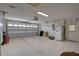Spacious two car garage with clean floors, shelving and work bench space for hobbies and storage at 8521 Caitlin Ct, Hudson, FL 34667
