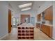 Modern kitchen featuring an island with wine rack, stainless steel appliances, and lots of light at 8521 Caitlin Ct, Hudson, FL 34667