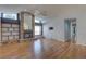 Open living room with a brick fireplace, built-in shelving, and hardwood flooring at 8521 Caitlin Ct, Hudson, FL 34667
