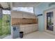 Cozy outdoor kitchen featuring a sink, cooktop, mini-fridge, and convenient bar area at 8521 Caitlin Ct, Hudson, FL 34667