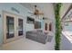 Outdoor living area featuring a ceiling fan, lights, a sitting area, and access to the pool at 8521 Caitlin Ct, Hudson, FL 34667