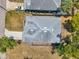 An aerial view captures the home's roof and driveway, highlighting its position in a quiet neighborhood at 8608 N Arden Ave, Tampa, FL 33604