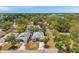 An aerial view of a well-maintained home nestled among lush greenery, showcasing its desirable neighborhood location at 8608 N Arden Ave, Tampa, FL 33604