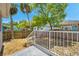 Inviting backyard with a mix of grassy and mulched areas, enclosed by a wooden fence for privacy at 8608 N Arden Ave, Tampa, FL 33604