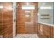 Modern tiled shower with a glass door and pebble floor at 8608 N Arden Ave, Tampa, FL 33604