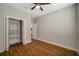 Bedroom featuring wood-look flooring, a ceiling fan, closet and neutral paint at 8608 N Arden Ave, Tampa, FL 33604