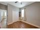 Cozy bedroom features wood-look flooring, natural light and closet at 8608 N Arden Ave, Tampa, FL 33604