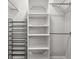 Closet featuring built-in shelving and clothing rods at 8608 N Arden Ave, Tampa, FL 33604
