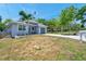 Charming single-story home with mature trees and a spacious front yard at 8608 N Arden Ave, Tampa, FL 33604