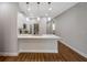 Modern kitchen has white cabinets, quartz counters, and stainless appliances at 8608 N Arden Ave, Tampa, FL 33604