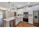 Beautiful kitchen boasts stainless steel appliances, white cabinets and quartz counters at 8608 N Arden Ave, Tampa, FL 33604
