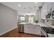 Bright kitchen features stainless steel appliances and island with sink at 8608 N Arden Ave, Tampa, FL 33604
