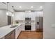 Modern kitchen featuring white cabinets, stainless steel appliances, and quartz countertops at 8608 N Arden Ave, Tampa, FL 33604