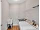 Convenient laundry room with washer, dryer, utility sink, and shelving at 8608 N Arden Ave, Tampa, FL 33604