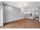 Bright living room with hardwood flooring and modern lighting open to the kitchen at 8608 N Arden Ave, Tampa, FL 33604