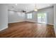 Spacious living room features ample light, wood-look tile and modern ceiling fan at 8608 N Arden Ave, Tampa, FL 33604