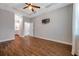 Spacious main bedroom with hardwood floors, tray ceiling, and en-suite bathroom access at 8608 N Arden Ave, Tampa, FL 33604