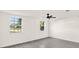 This bedroom has two bright windows and a ceiling fan at 9266 Century Dr, Spring Hill, FL 34606