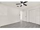 This bedroom features a ceiling fan, closet, and gray flooring at 9266 Century Dr, Spring Hill, FL 34606