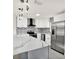 Modern kitchen featuring quartz countertops, stainless steel appliances, and bar stool seating at 9266 Century Dr, Spring Hill, FL 34606
