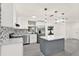 Bright kitchen featuring stainless appliances, white cabinets, island with quartz countertop, and modern lighting at 9266 Century Dr, Spring Hill, FL 34606