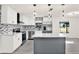Bright kitchen featuring stainless appliances, white cabinets, island with quartz countertop, and modern lighting at 9266 Century Dr, Spring Hill, FL 34606