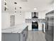 Remodeled kitchen featuring stainless appliances, stylish cabinets, white counters and an island with bar stool seating at 9266 Century Dr, Spring Hill, FL 34606
