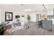 Open-concept living space with modern decor, barstool seating, and sliding glass doors at 9266 Century Dr, Spring Hill, FL 34606