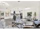 Open concept living area featuring modern light fixtures, gray tones, and backyard views at 9266 Century Dr, Spring Hill, FL 34606