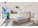 Bright main bedroom featuring neutral paint, modern fan, and lush outdoor views at 9266 Century Dr, Spring Hill, FL 34606