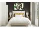 Comfortable main bedroom featuring a plush bed, stylish decor, and ambient lighting at 9351 Raised Tulip Ln, Land O Lakes, FL 34637