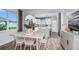 Open-concept dining area featuring modern decor, wood flooring, and abundant natural light at 9542 Coastline Way, Parrish, FL 34219