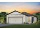 Charming single-story home featuring a two-car garage and beautifully landscaped front yard at 9542 Coastline Way, Parrish, FL 34219