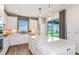 Bright kitchen with quartz countertops, stainless appliances, an island, a mosaic tile backsplash, and wood flooring at 9542 Coastline Way, Parrish, FL 34219