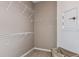 Walk-in closet with wire shelving and ample storage space in neutral color scheme at 9542 Coastline Way, Parrish, FL 34219