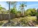 Lush backyard with mature trees and a wood fence at 970 Ridgewood Ter, Tarpon Springs, FL 34689