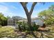 Home backyard featuring a screened-in pool area and mature trees at 970 Ridgewood Ter, Tarpon Springs, FL 34689
