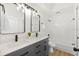 Updated bathroom features dual sinks, modern fixtures, and tiled shower and bathtub at 970 Ridgewood Ter, Tarpon Springs, FL 34689