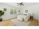 Bright bedroom with hardwood floors and fan at 970 Ridgewood Ter, Tarpon Springs, FL 34689