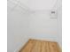 Spacious walk-in closet with wire shelving and hardwood floors at 970 Ridgewood Ter, Tarpon Springs, FL 34689