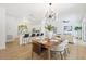 Open-concept dining room with modern chandelier, seamlessly connecting to the kitchen and living area at 970 Ridgewood Ter, Tarpon Springs, FL 34689