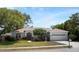 Charming single-story home featuring a well-manicured lawn, double front doors, and attached two-car garage at 970 Ridgewood Ter, Tarpon Springs, FL 34689