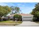 Charming home with well-manicured lawn, mature trees, and a two-car garage at 970 Ridgewood Ter, Tarpon Springs, FL 34689