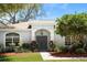 Charming home featuring a light exterior, manicured lawn, and inviting double door entry at 970 Ridgewood Ter, Tarpon Springs, FL 34689