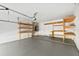 Clean garage featuring epoxy floor, shelving, and ample storage space at 970 Ridgewood Ter, Tarpon Springs, FL 34689