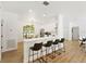 Modern kitchen with sleek white cabinets, stainless steel appliances, and a breakfast bar with seating at 970 Ridgewood Ter, Tarpon Springs, FL 34689