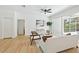 Bright living room features hardwood floors, fan, and large glass door to pool area at 970 Ridgewood Ter, Tarpon Springs, FL 34689