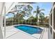 Enclosed pool with clear blue water, a screened enclosure, and plenty of space for lounging at 970 Ridgewood Ter, Tarpon Springs, FL 34689