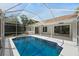 Large screened-in pool area features clear blue water, spacious deck, and outdoor living space at 970 Ridgewood Ter, Tarpon Springs, FL 34689